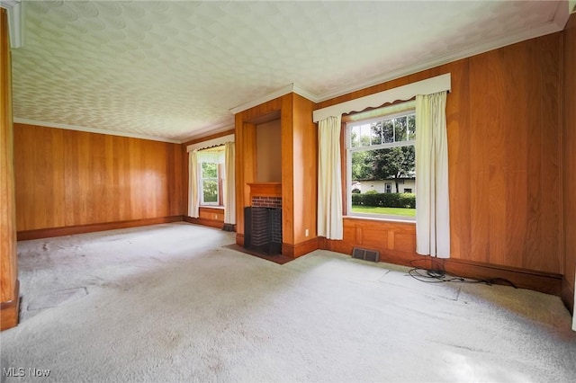 1237 Center St, Ashland, OH 44805 - unfurnished living room with carpet floors, wood walls, a fireplace with flush hearth, and crown molding