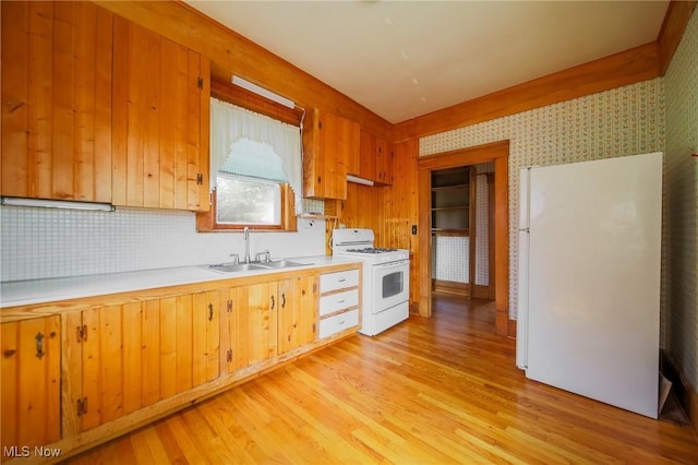 1237 Center St, Ashland, OH 44805 - kitchen featuring white appliances, light countertops, light wood-style flooring, decorative backsplash, and wallpapered walls