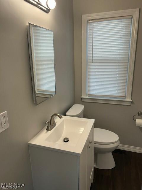 1975 9th St SW, Akron, OH 44314 - half bathroom featuring vanity and wood finished floors