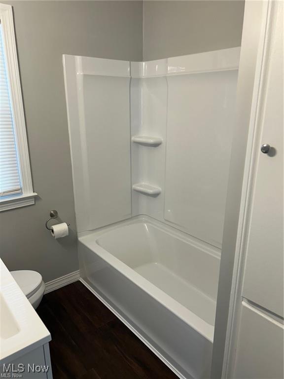 1975 9th St SW, Akron, OH 44314 - bathroom featuring wood finished floors, vanity, and shower / bath combination
