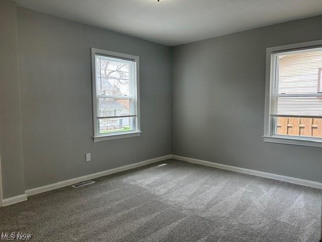 1975 9th St SW, Akron, OH 44314 - spare room with carpet floors and baseboards