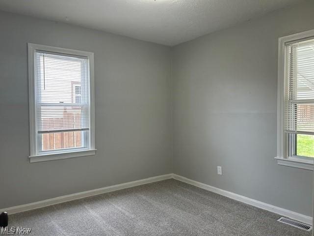 1975 9th St SW, Akron, OH 44314 - carpeted empty room featuring baseboards