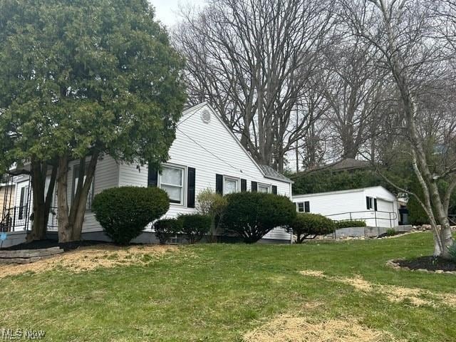 1975 9th St SW, Akron, OH 44314 - view of property exterior with a lawn