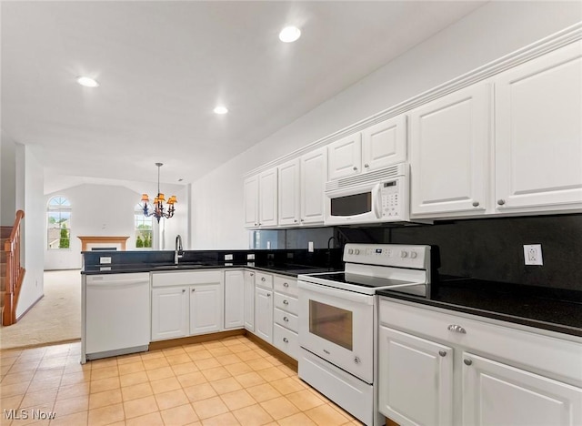 9151 Springfield Rd Unit 1603, Poland, OH 44514 - kitchen featuring white appliances, a chandelier, a peninsula, white cabinetry, and dark countertops