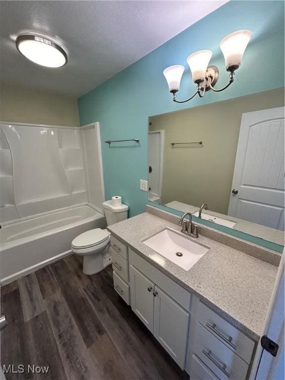 10545 Main St, Norwich, OH 43767 - full bathroom featuring vanity, wood finished floors, washtub / shower combination, a chandelier, and a textured ceiling