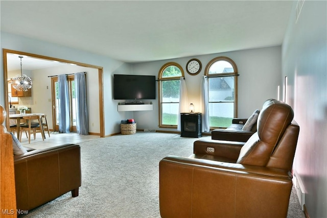 2304 Bianca Ln, Cortland, OH 44410 - living area with carpet flooring, plenty of natural light, a chandelier, and a wood stove