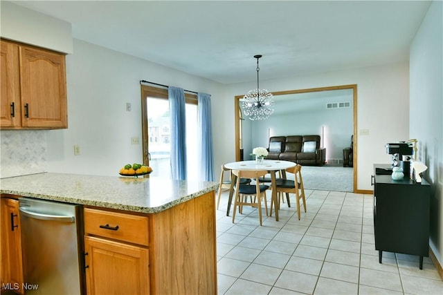 2304 Bianca Ln, Cortland, OH 44410 - kitchen with a chandelier, a peninsula, light tile patterned floors, hanging light fixtures, and light stone countertops