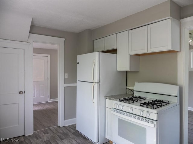 3814 Russell Ave, Parma, OH 44134 - kitchen featuring white appliances, dark wood finished floors, white cabinets, a textured ceiling, and light stone countertops