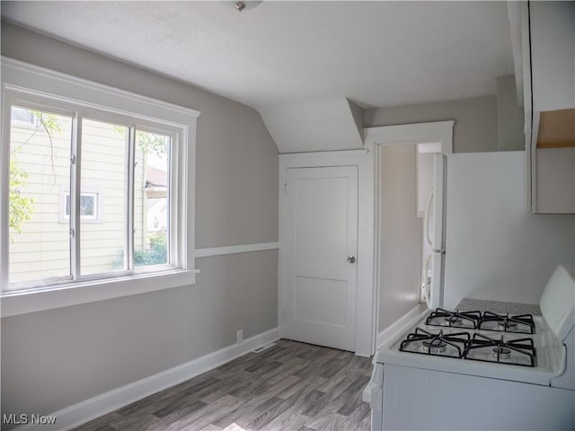 3814 Russell Ave, Parma, OH 44134 - kitchen featuring white appliances, light wood-style floors, and vaulted ceiling
