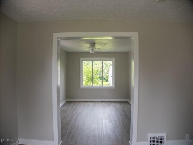 3814 Russell Ave, Parma, OH 44134 - empty room featuring wood finished floors, a ceiling fan, and a textured ceiling