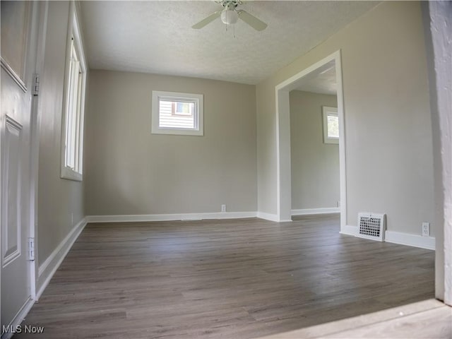 3814 Russell Ave, Parma, OH 44134 - spare room with dark wood-type flooring, ceiling fan, and a textured ceiling