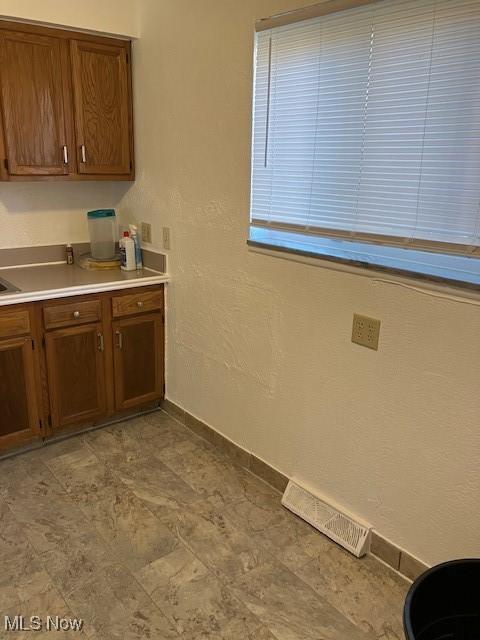 4958 Caroline Dr Unit 6, Warrensville Heights, OH 44128 - kitchen featuring brown cabinets and light countertops