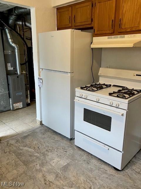 4958 Caroline Dr Unit 6, Warrensville Heights, OH 44128 - kitchen featuring white appliances, under cabinet range hood, brown cabinetry, heating unit, and light countertops