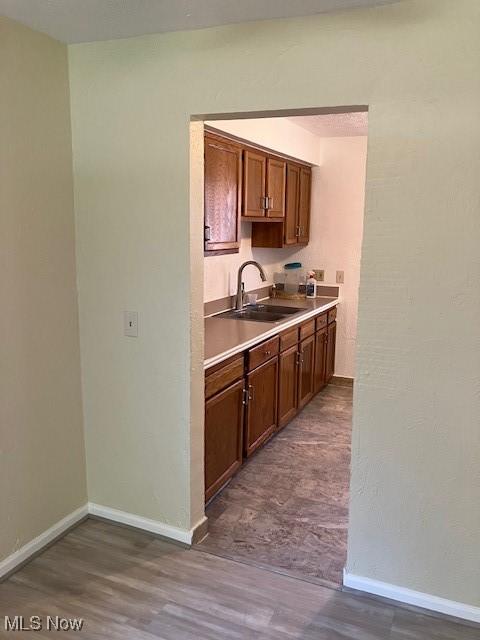 4958 Caroline Dr Unit 6, Warrensville Heights, OH 44128 - kitchen with dark wood finished floors, brown cabinets, and light countertops
