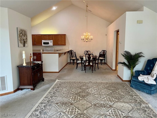9264 Sharrott Rd Unit 104, Youngstown, OH 44514 - dining room with light colored carpet, a chandelier, and high vaulted ceiling