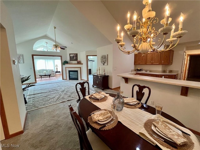 9264 Sharrott Rd Unit 104, Youngstown, OH 44514 - dining room featuring light colored carpet, vaulted ceiling, a tiled fireplace, a chandelier, and a ceiling fan