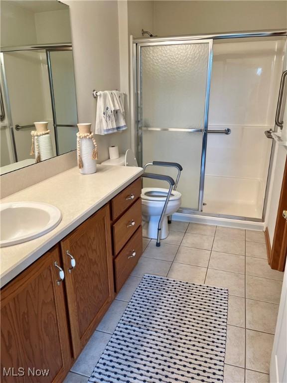 9264 Sharrott Rd Unit 104, Youngstown, OH 44514 - full bathroom with vanity, a shower stall, and tile patterned floors