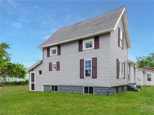 1229 W 45th St, Ashtabula, OH 44004 - rear view of property with a yard, a shingled roof, and entry steps