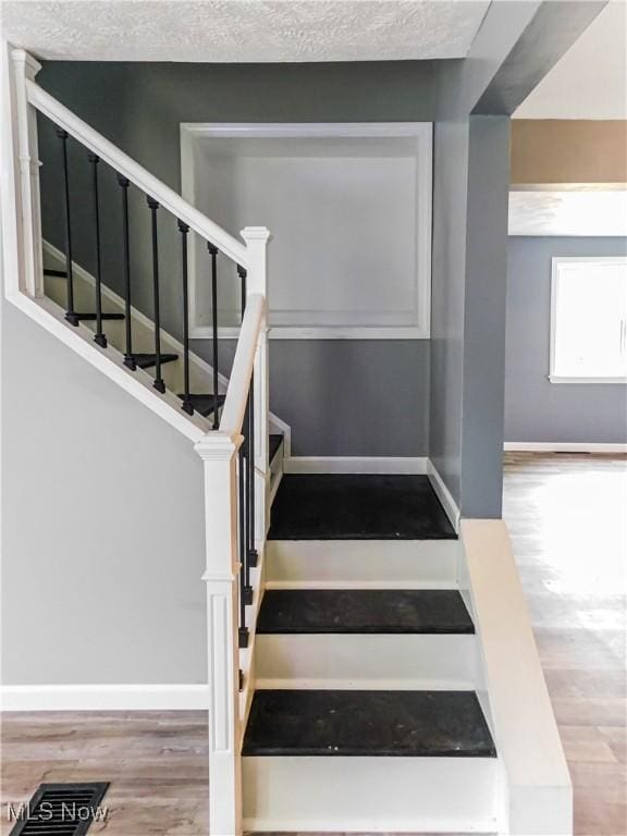 1229 W 45th St, Ashtabula, OH 44004 - stairway with wood finished floors and baseboards
