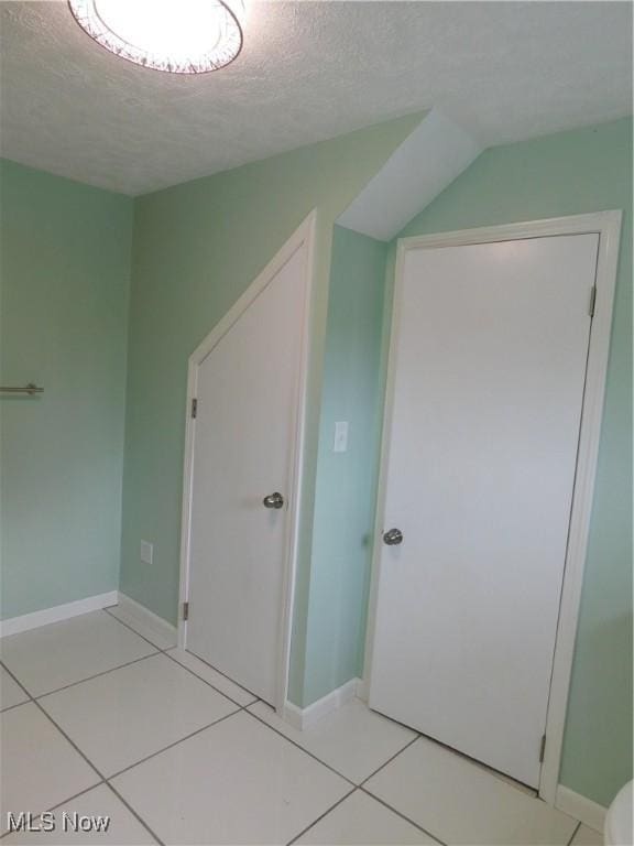 1229 W 45th St, Ashtabula, OH 44004 - additional living space with a textured ceiling and light tile patterned flooring