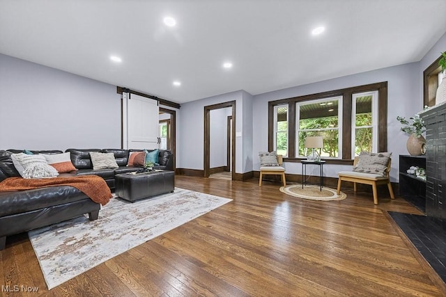 3549 Kent Rd, Stow, OH 44224 - living room featuring wood finished floors, a fireplace with flush hearth, recessed lighting, and a barn door