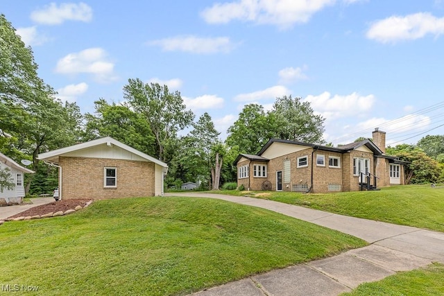 3549 Kent Rd, Stow, OH 44224 - view of front of property featuring brick siding, a front yard, and a chimney