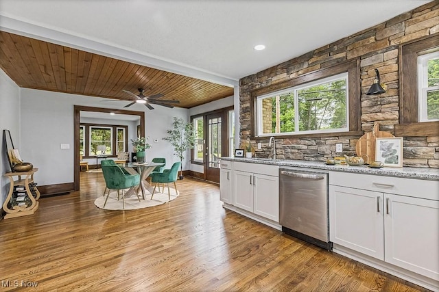 3549 Kent Rd, Stow, OH 44224 - kitchen featuring stainless steel dishwasher, white cabinetry, light stone counters, light wood-style floors, and a ceiling fan