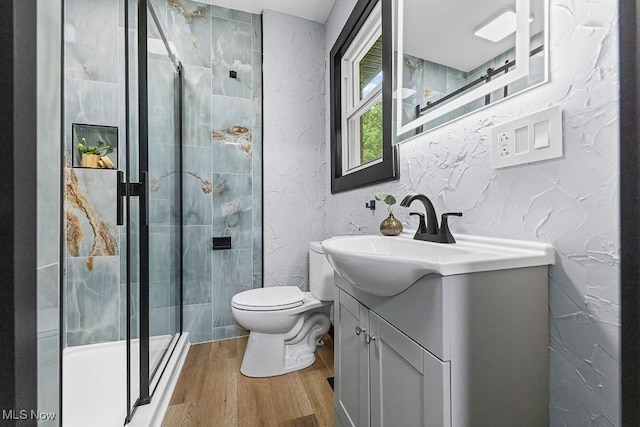 3549 Kent Rd, Stow, OH 44224 - bathroom with vanity, wood finished floors, a textured wall, and a shower stall