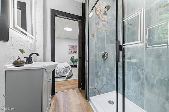 3549 Kent Rd, Stow, OH 44224 - ensuite bathroom featuring vanity, a stall shower, and wood finished floors