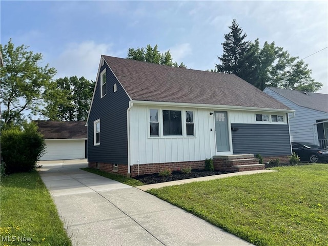 16005 Walvern Blvd, Maple Heights, OH 44137 - view of front of home featuring roof with shingles, a front lawn, board and batten siding, an outbuilding, and a garage