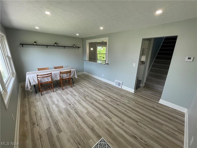 16005 Walvern Blvd, Maple Heights, OH 44137 - dining area featuring a textured ceiling, wood finished floors, recessed lighting, and stairs