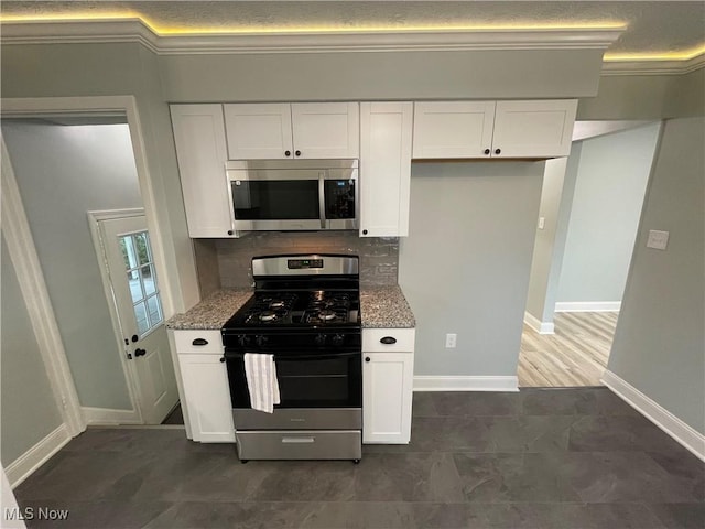 16005 Walvern Blvd, Maple Heights, OH 44137 - kitchen with appliances with stainless steel finishes, light stone counters, white cabinets, ornamental molding, and backsplash