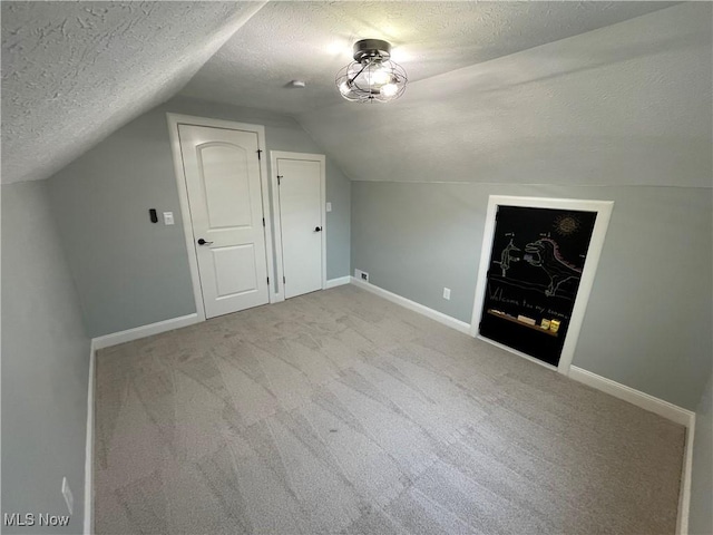 16005 Walvern Blvd, Maple Heights, OH 44137 - bonus room with a textured ceiling, carpet flooring, and lofted ceiling