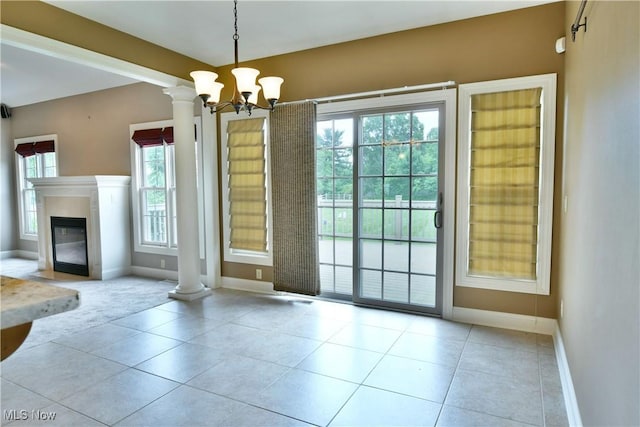 3455 Winners Cir, Canfield, OH 44406 - unfurnished dining area with tile patterned floors, decorative columns, a chandelier, carpet floors, and a glass covered fireplace