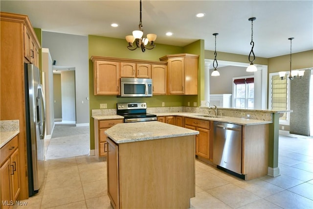 3455 Winners Cir, Canfield, OH 44406 - kitchen with appliances with stainless steel finishes, a chandelier, a peninsula, a center island, and light stone countertops