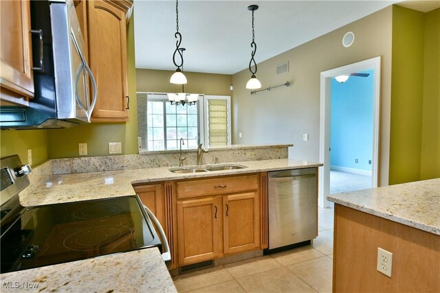 3455 Winners Cir, Canfield, OH 44406 - kitchen with stainless steel appliances, a peninsula, decorative light fixtures, a chandelier, and light stone countertops