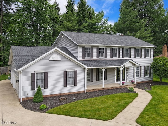 4314 Cheval Cir, Stow, OH 44224 - view of front facade featuring a shingled roof, covered porch, a front yard, and a garage