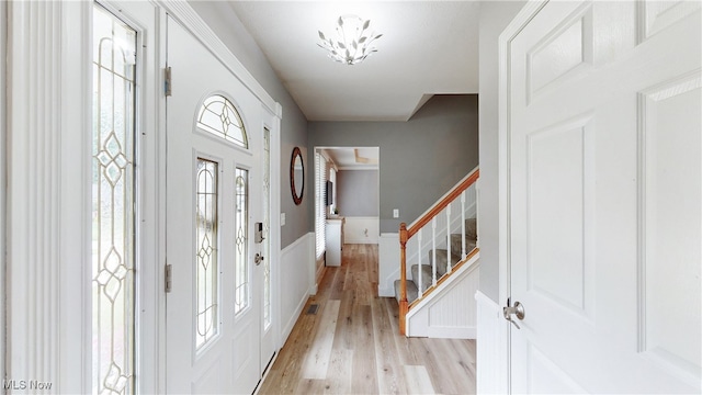 4314 Cheval Cir, Stow, OH 44224 - entryway with light wood-style flooring, stairs, and a wainscoted wall