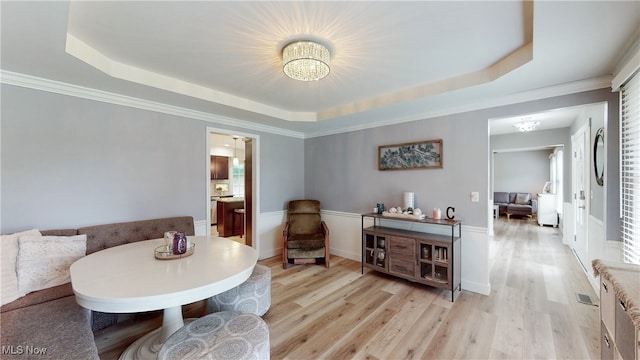 4314 Cheval Cir, Stow, OH 44224 - dining room featuring a chandelier, a tray ceiling, and light wood-style floors