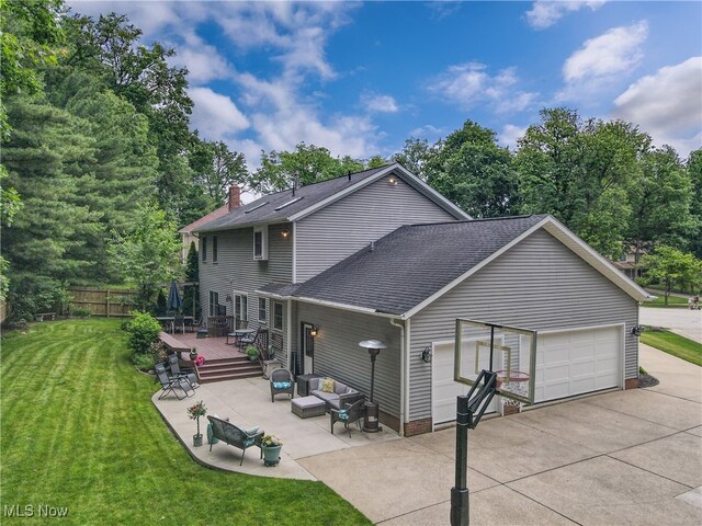 4314 Cheval Cir, Stow, OH 44224 - back of house with a deck, roof with shingles, a chimney, a garage, and outdoor lounge area