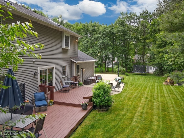 4314 Cheval Cir, Stow, OH 44224 - wooden terrace with a trampoline, a yard, a patio area, an outdoor living space, and view of scattered trees