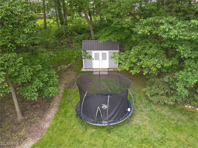 4314 Cheval Cir, Stow, OH 44224 - view of grassy yard with a trampoline and a storage unit