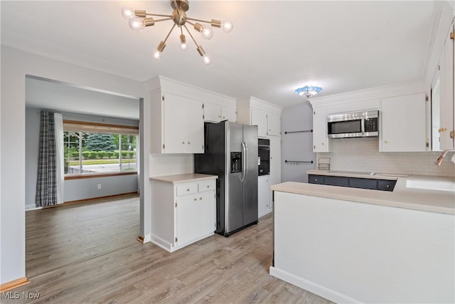 541 Broad St, Wadsworth, OH 44281 - kitchen with stainless steel appliances, backsplash, white cabinets, light wood-style floors, and light countertops