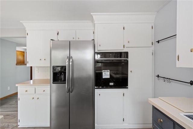 541 Broad St, Wadsworth, OH 44281 - kitchen featuring stainless steel fridge with ice dispenser, black oven, white cabinets, decorative backsplash, and light wood-type flooring