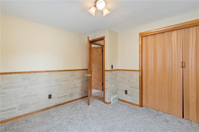 541 Broad St, Wadsworth, OH 44281 - unfurnished bedroom featuring a wainscoted wall and carpet