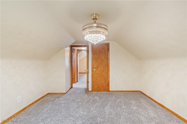 541 Broad St, Wadsworth, OH 44281 - additional living space with carpet floors, vaulted ceiling, and a chandelier