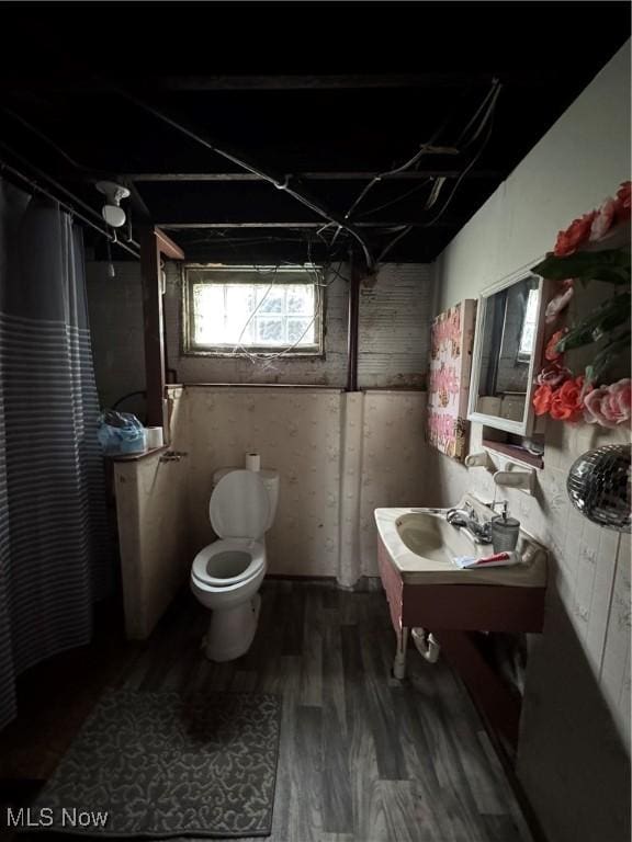 1201 Jackson St SW, Massillon, OH 44647 - bathroom with curtained shower and wood finished floors