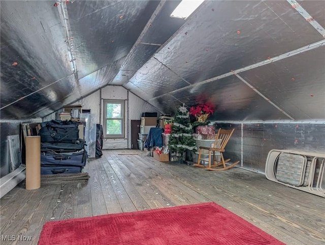 414 W Maple St, Hartville, OH 44632 - additional living space with hardwood / wood-style flooring and vaulted ceiling