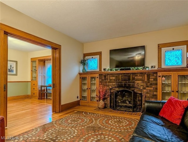 414 W Maple St, Hartville, OH 44632 - living room with wood finished floors and a brick fireplace