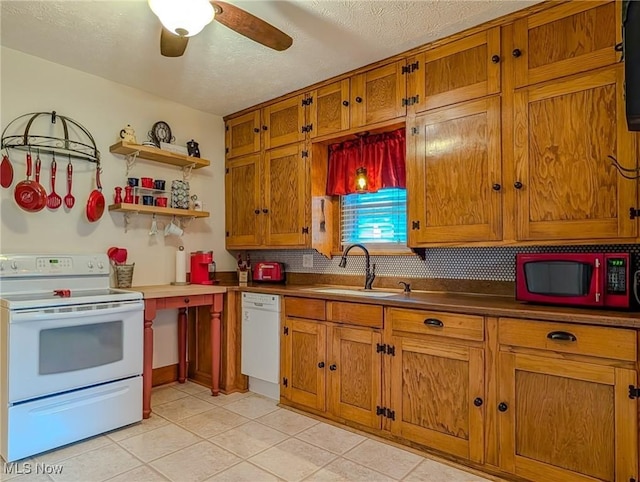 414 W Maple St, Hartville, OH 44632 - kitchen with white appliances, brown cabinets, backsplash, light tile patterned floors, and ceiling fan